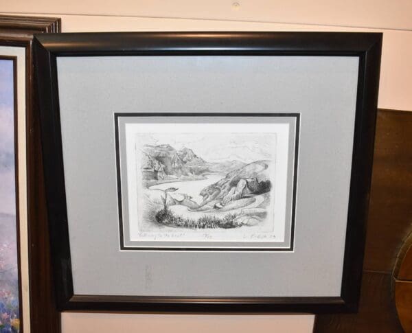 Black and white print of a mountain landscape.