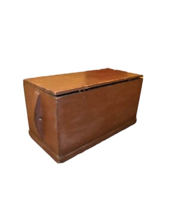 Wooden chest with hinged lid and handles.