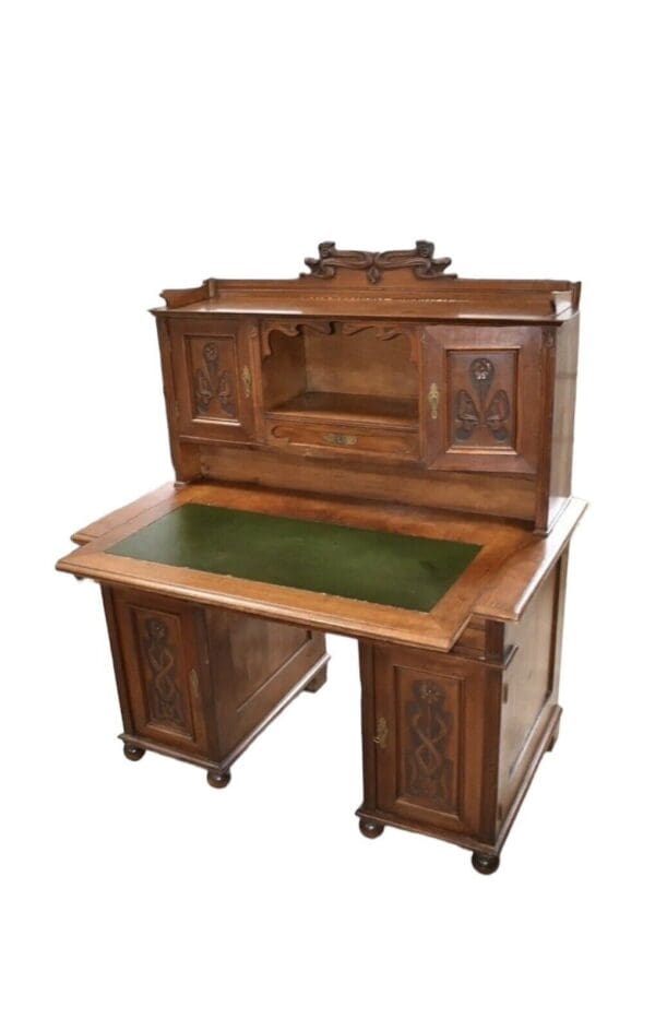 Antique wooden desk with green top.